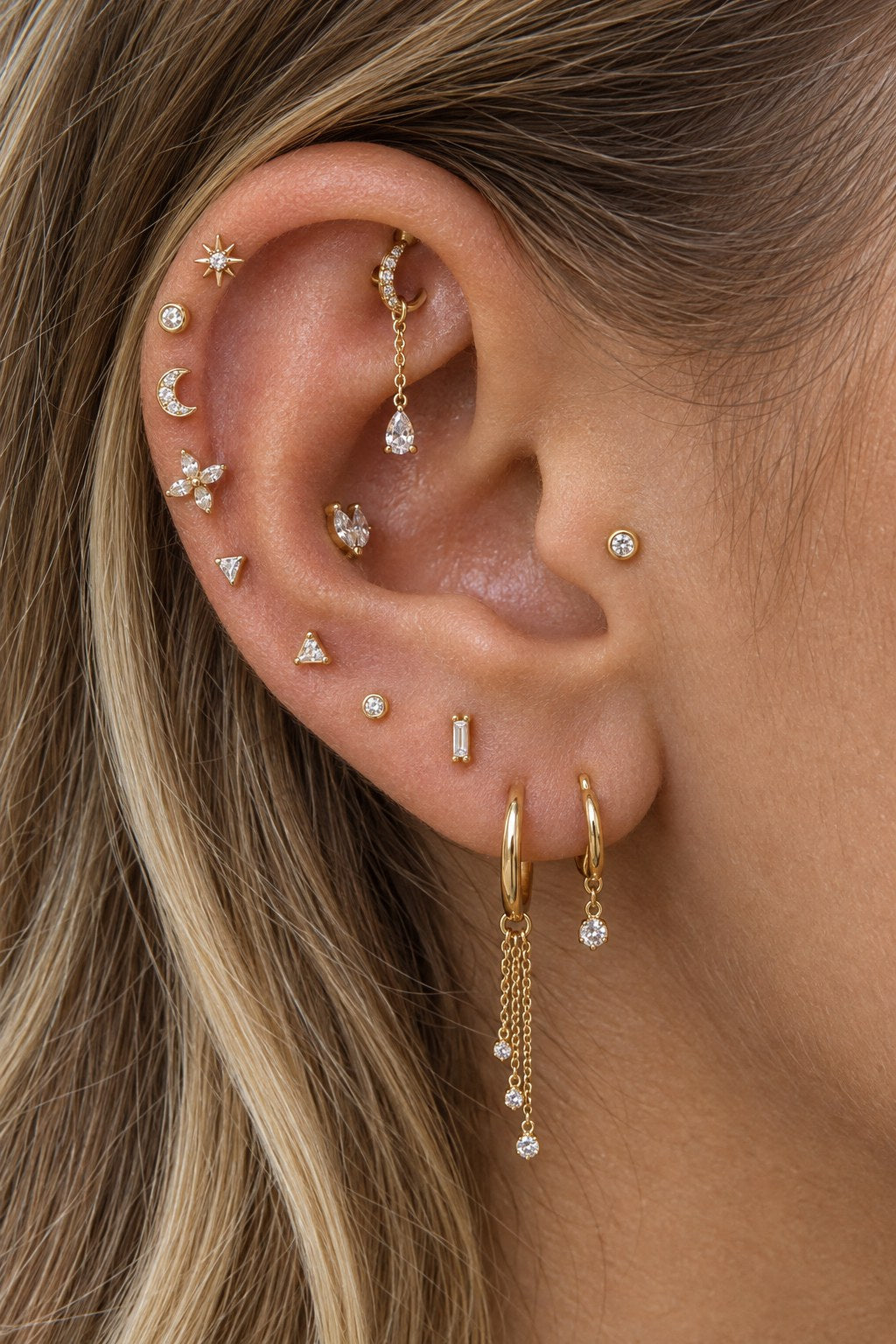 Curated gold ear stack with sparkling studs and chain drop hoops