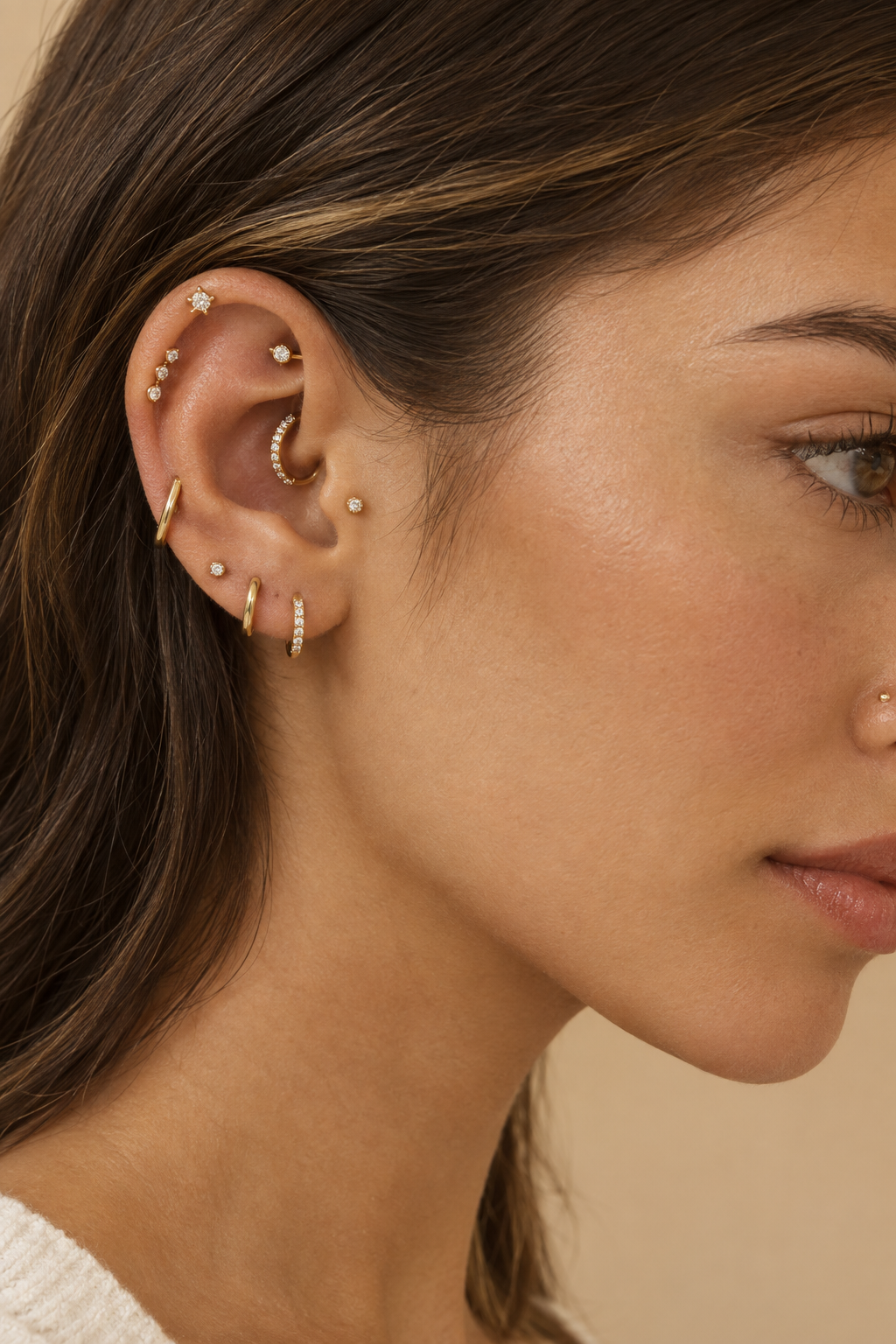 Ear, cartilage and nose piercings with gold and crystal jewelry at Lenozella piercing studio in Miami